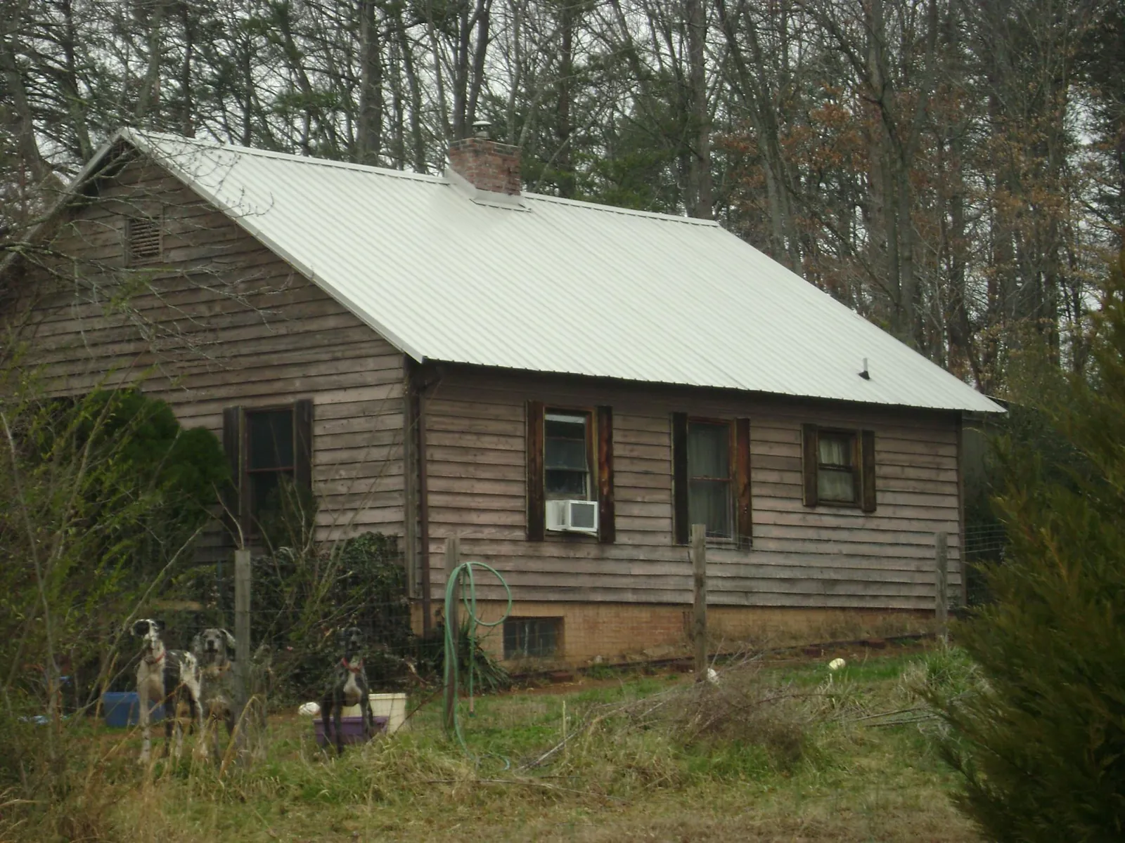 White metal roof on an old wood sided farmhouse, from a Metal Roof Installation job in Anderson